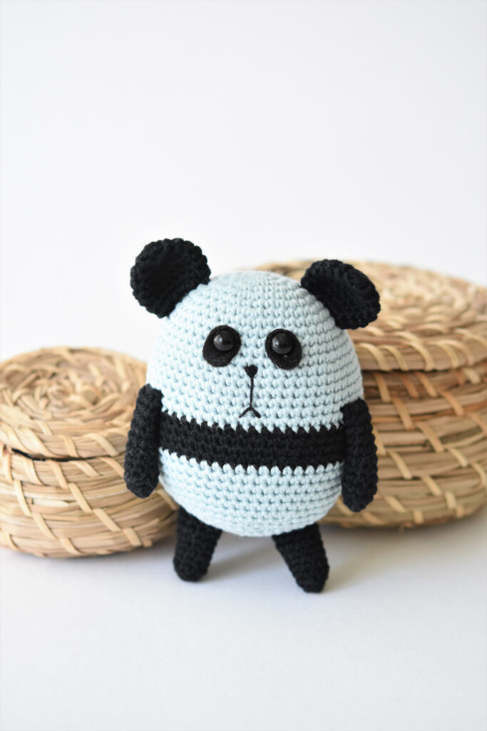 A small balloon-shaped amigurumi panda, bright and whimsical.
