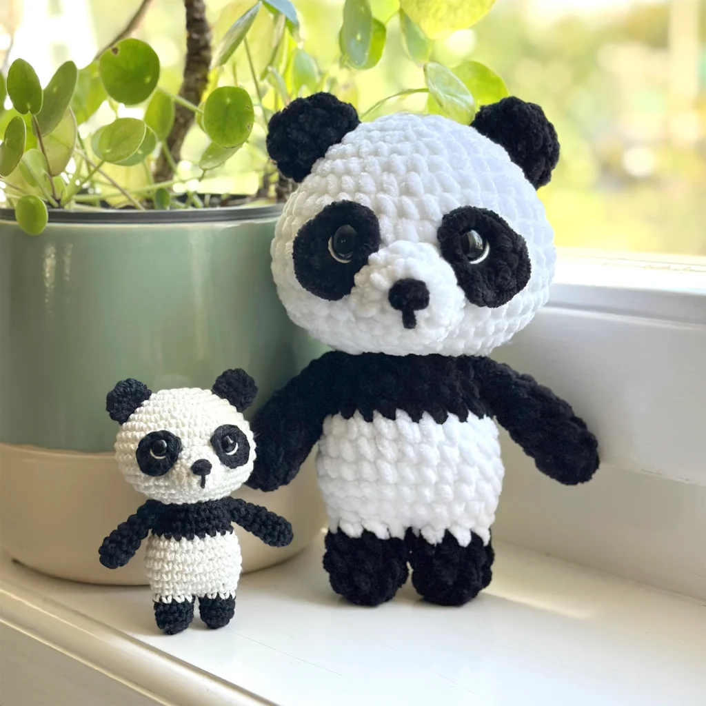 A small amigurumi panda bear, named Pepe, looking cute and cheerful.