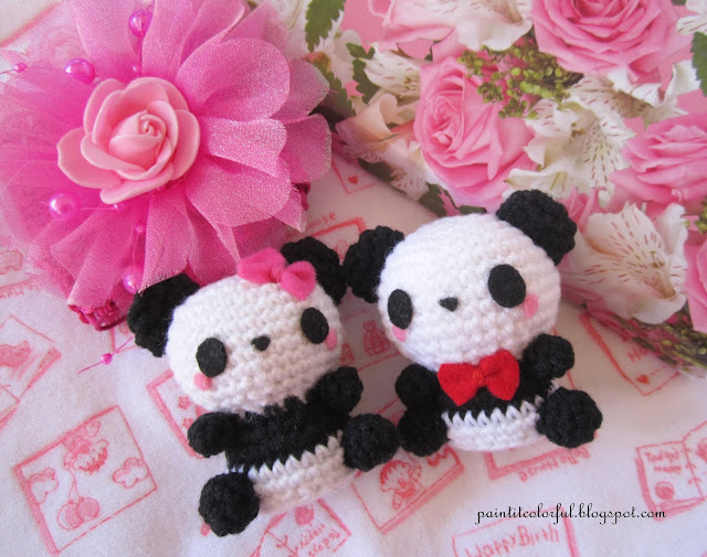 Two small amigurumi panda figures in black and white.
