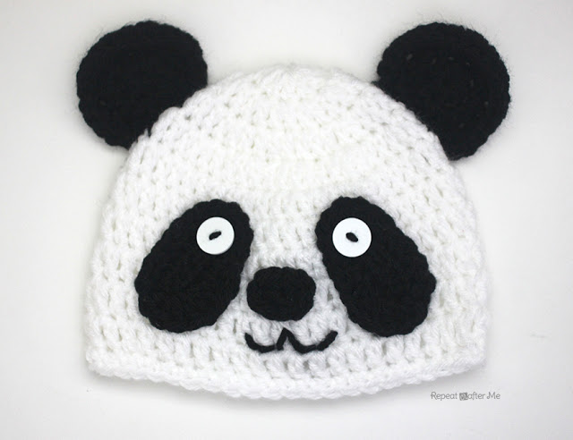 A crochet panda bear hat, playful with ears on top, in black and white.